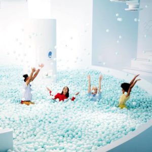 People frolicking in a ball pit.